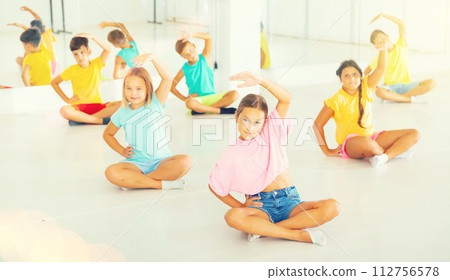 Group of emotional children doing yoga in dance studio 112756578