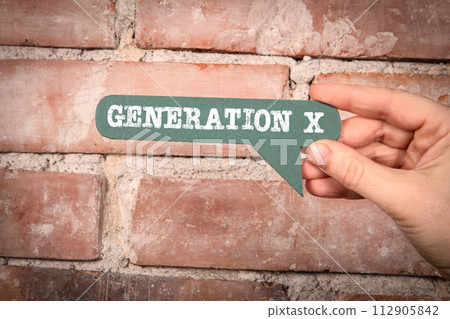 Generation X Concept. Green speech bubble with text on a red brick background 112905842