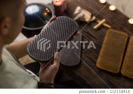 Sadhu board, yoga board with nails, guy stands on the board with nails, yoga concept 112118818