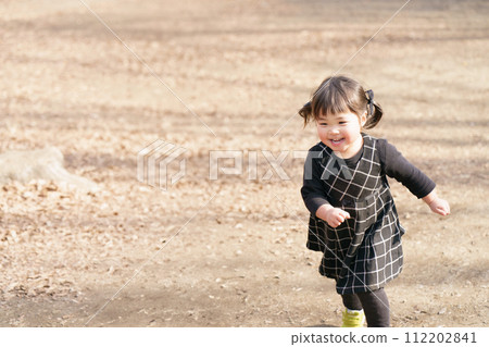 little girl running in the park 112202841