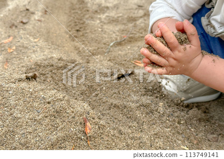 Children's hands playing in the sandbox 113749141