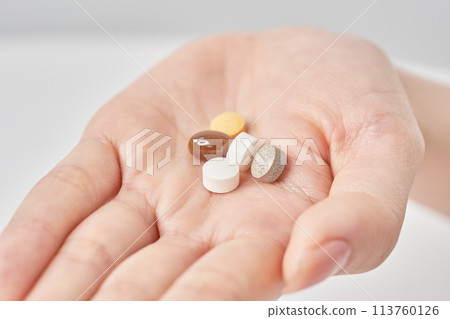 Various pills on a hand 113760126