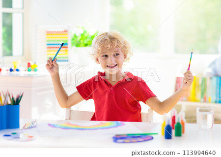 Kids paint. Child painting. Little boy drawing. 113994640