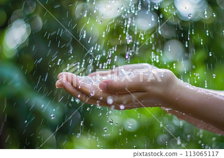 Person Holding Out Hand Under Rain Shower 113065117