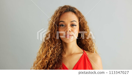 Happy woman person, wink and laughing in studio, excited and flirt on grey background. Cheerful, joyful and smile on female model face, friendly and natural with curly hair of fun African Lady 113347027