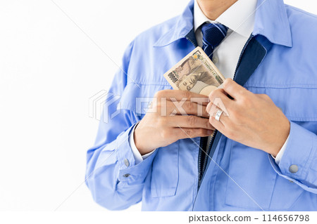 Man in work clothes, stack of bills, no face 114656798