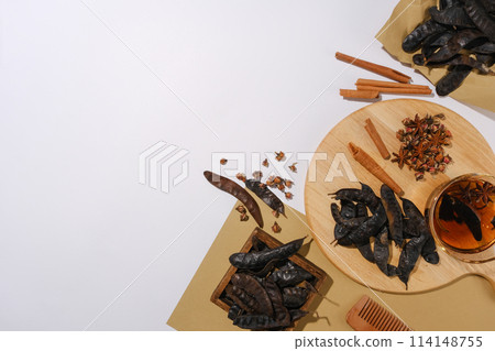 Photo from top view at vintage concept with a wooden tray and some vintage paper contain medicine herbs above. Template for organic product advertise, which has ingredients from nature 114148755