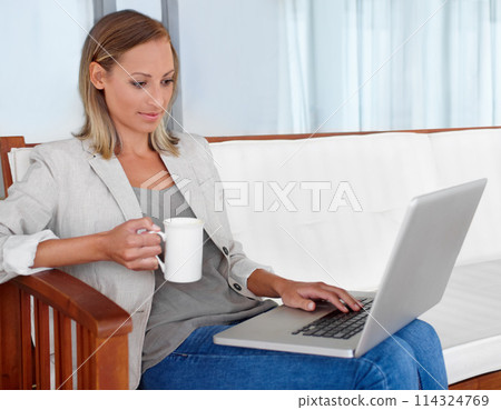 Laptop, coffee and woman in home for remote work, freelance career and business in living room. House, desk and person on computer for online research, website blog and social networking for job 114324769