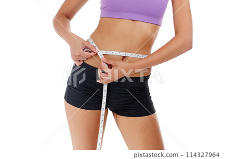 Health, fitness and woman with measuring tape for waist, weight goal with diet and exercise on white background. Stomach, body and wellness, check progress for weightloss and measurement in studio 114327964