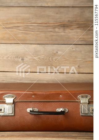 Old shabby leather portable suitcase for travel trip on grey background with copy space 115567794