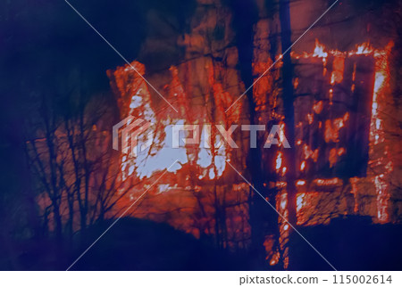 small wooden cottage on fire at night 115002614