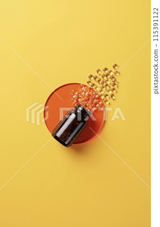 the yellow pills pouring out of the vat 115391122