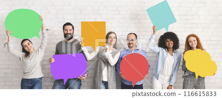 Global communications. Group of happy young diverse people holding empty colorful speech bubbles and smiling at camera 116615833