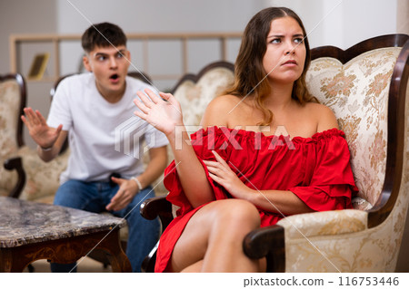 Disgruntled young husband swears at his wife 116753446