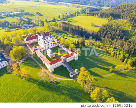 Hora Matky Bozi Monastery in Dolni Hedec, Czechia. The monastery is nestled on a hilltop overlooking the town and countryside. The photo showcases the unique architecture and the scenic landscape. 116935212