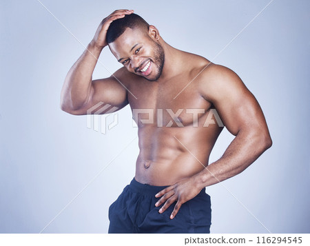 Black man, portrait and topless fitness in studio, strong arms and muscle on blue background. Male person, confidence and athlete for power or healthy body, bodybuilder and shirtless for six pack 116294545