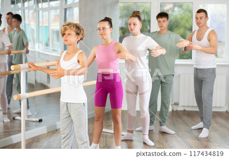 Girls and boys in ballet class perform second position 117434819