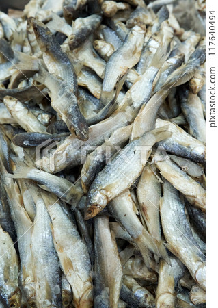 A large assortment of dried fish is on display in the Asian store. 117640494