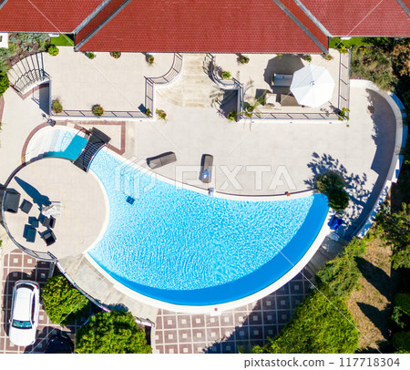 An Aerial View showcasing a Stunning Resort Pool surrounded by Comfortable Lounge Chairs 117718304