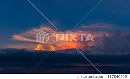 Cumulonimbus clouds in the blue summer sky, dyed by the setting sun. a-2 High saturation contrast 117840519