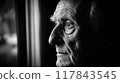 An elderly man's reflective gaze through a window during a quiet afternoon, capturing a moment of contemplation and solitude. Generative AI 117843545