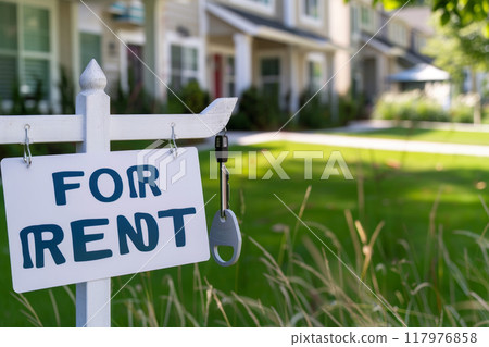 Sign FOR RENT on a green clearing against the background of a house for rent 117976858