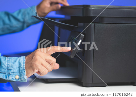 The man using the laser printer. 117016242