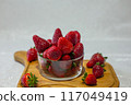 Fresh strawberries in a bowl on the table 117049419