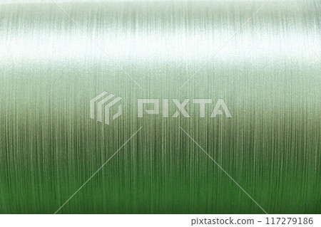 Closed up of green color of thread textured background (Focus at center of picture) 117279186