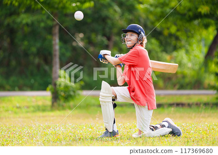 Kids playing cricket in summer park 117369680