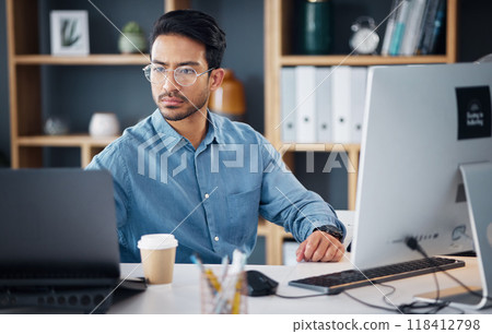 Serious, laptop and business man in office for startup management, digital planning and trading. Focused male worker at computer technology for online project, website and internet research at table 118412798