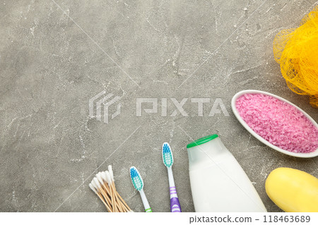 Bottle of pink shower gel, soap, bath salt and toothbrush on grey background 118463689