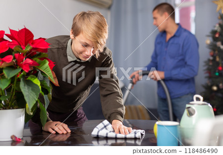 Son helps his father to clean room before christmas 118486490