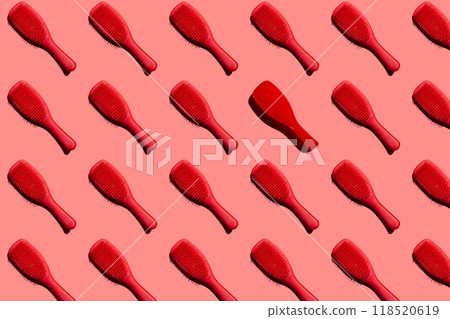 Creative layout featuring red hair brushes on pink background, repeating collage 118520619