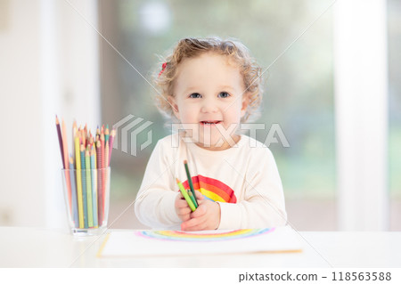 Kids paint. Child painting. Little girl drawing. 118563588