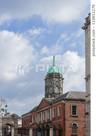 Clock tower of Dublin Castle with distinctive green dome and clock face under blue cloudy sky 118652276