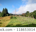 View of Hoverla Mountain in the Carpathians from the countryside grows green grass and a design for drying grass horizontal 118653014