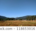 View of Hoverla Mountain in the Carpathians from the countryside grows green grass and a design for drying grass horizontal 118653016