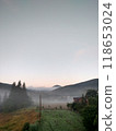 Village in mountains with the view on forest of fir mountains in fog rural vertical 118653024