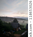 Village in mountains with the view on forest of fir mountains in fog rural vertical 118653026