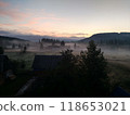 Village in mountains with the view on forest of fir mountains in fog rural horizontal 118653021