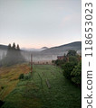 Village in mountains with the view on forest of fir mountains in fog rural vertical 118653023