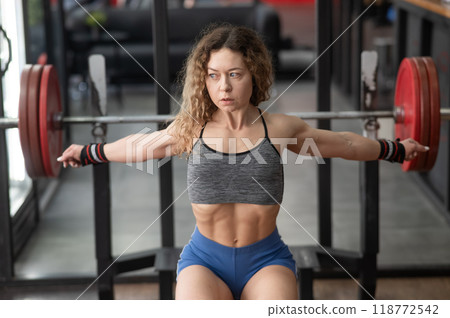 Middle aged woman warming up before bench press at the gym.  118772542