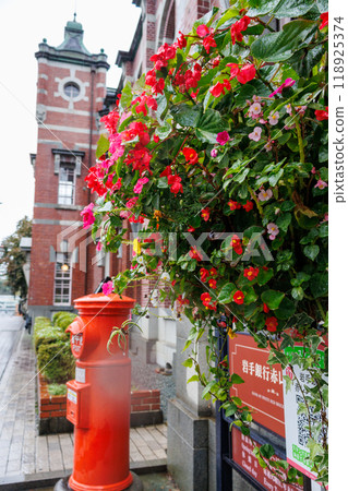 A historic brick building soaked in the rain 118925374