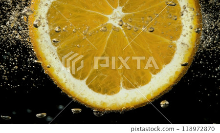 Macro Shot of Fresh Orange Slice in Water with Air Bubbles 118972870