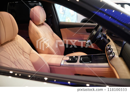 Interior of new car cabin with automatic gearbox featuring beige leather upholstery and modern looking design 118100333