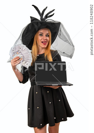 Smiling witch holding a laptop with blank screen and showing a fan of dollars 118248902