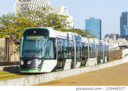 The circular light rail train drives past Pier-2 Art Center in Kaohsiung, Taiwan. 119446327