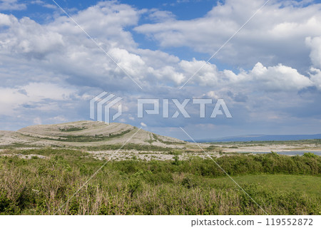 Landscape of Burren National Park in Ireland, with limestone hills under a dynamic sky 119552872