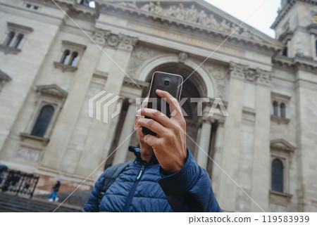 poses in front of St Stephens Basilica in Budapest 119583939